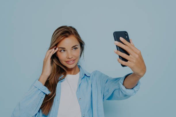 istock Gorgeous model making selfie on mobile phone 1475068668