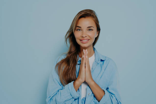 istock Happy cheerful pleasant looking female pleads for something 1475068677
