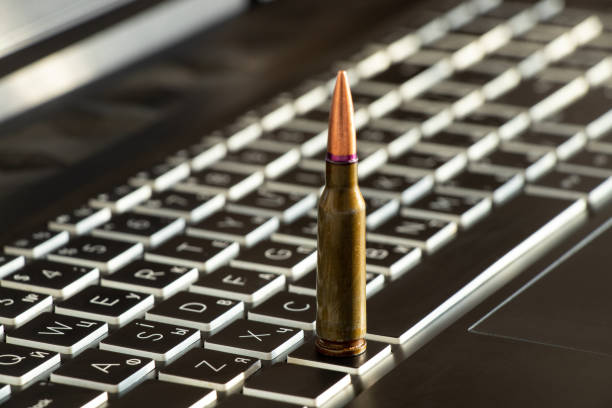 istock One bullet stands on a black laptop keyboard close-up 1475073000