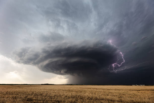 Powerful supercell thunderstorm in Kansas Lightning strikes from a powerful supercell thunderstorm over a field near Greensburg, Kansas. dramatic sky stock pictures, royalty-free photos & images