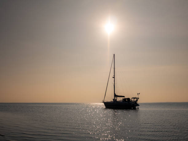 istock Backlit sailboat on a sunny day, Waddensea, Netherlands 1475073202