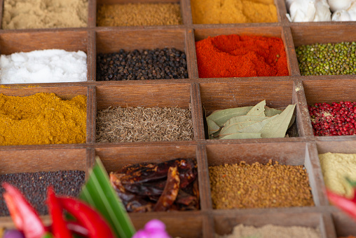 Indian spices in wooden display.