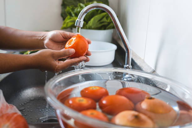istock Female hand washing vegetables and sanitizing 1475076177