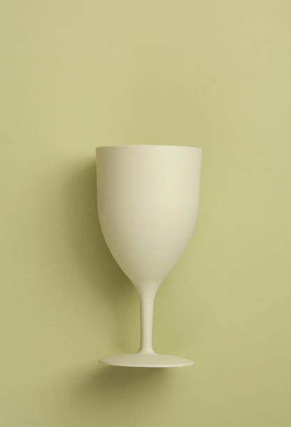 istock Plastic wine glass on a green background 1475076236