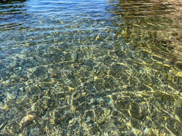 istock Clear water pebbles stones at the seabed. 1475076903