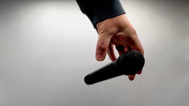 istock Drop the Mic on Sequence - Male Hand Black Mic 1475078553