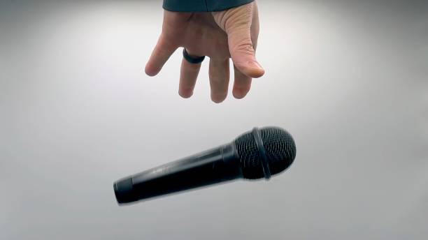 istock Drop the Mic on Sequence - Male Hand Black Mic 1475078559