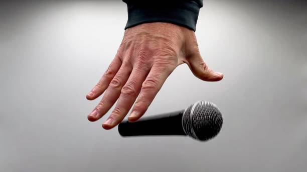 istock Drop the Mic on Sequence - Male Hand Black Mic 1475079097