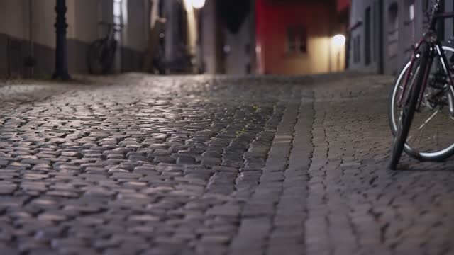 Misterious coblestone  pavement illuminated street in Cologne, Germany, establishment shot