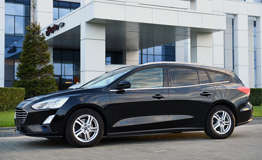 Belarus, Minsk -23.09.2022:A black 2019 Ford Focus wagon pulled up outside the hotel Hilton.