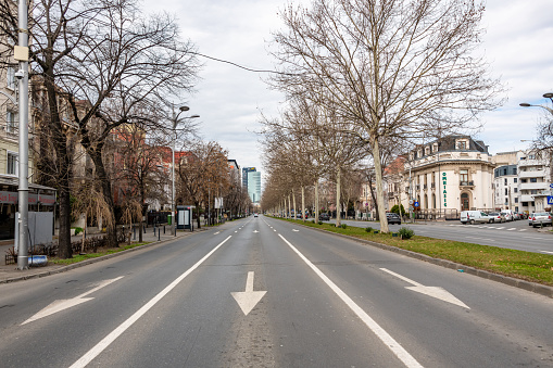 Bucharest, Romania. March 12, 2023: Empty road in central Bucharest witj traffic in the distance.