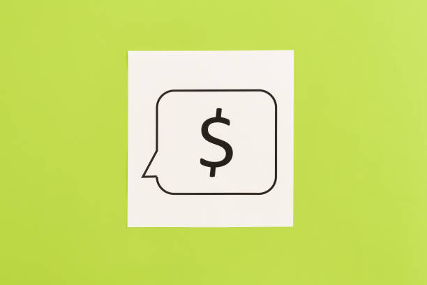 istock Dollar sign on white paper on green background, flat lay. 1475090364
