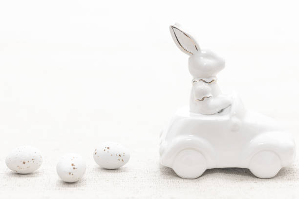 istock Decorative ceramic hare in a car and Easter eggs, close-up. 1475093830