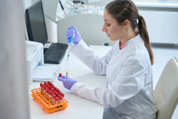 istock Woman in overalls and protective gloves work in testing unit 1475094413