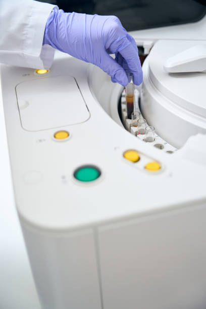 istock Laboratory assistant removes a test tube with a biomaterial sample 1475094426