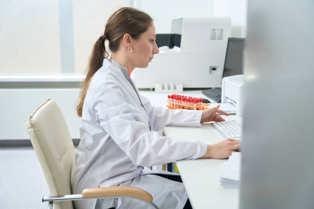 istock Laboratory assistant makes a printout of the results 1475094435