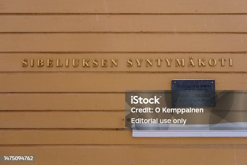 A sign saying Birthplace of Jean Sibelius in Finnish on the wall of the childhood home of the Finnish composer.