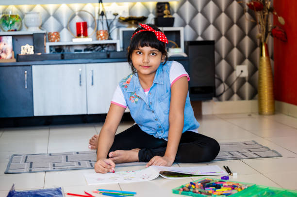 istock Girl Drawing On Notebook While Relaxing On Floor In Living Room 1475097876