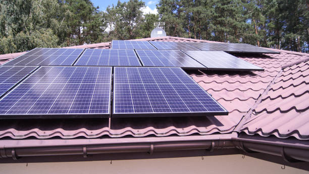 istock Solar panels on a roof and trees on a background | Eco Solution For Renewable Energy 1475099834