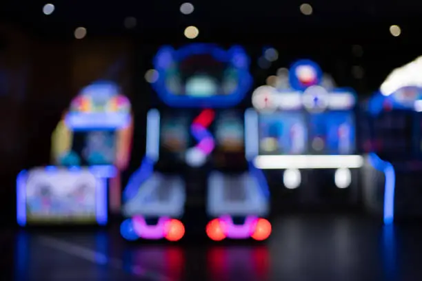 Photo of blurred background of entertainment Arcade simulator machines
