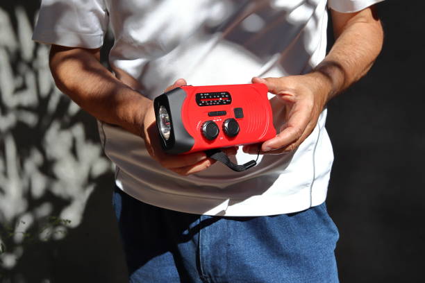 Red portable radio rechargeable with solar panels or manually with a crank