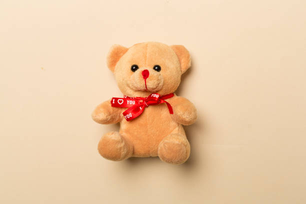 istock Cute teddy bear on color background, top view 1475102426