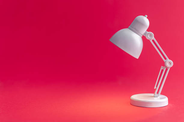 istock White table lamp on a Viva Magenta background, copy space. 1475102677