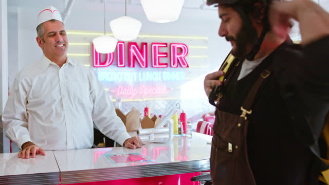 Delivery Person Leaves With An Order In a 1950s Styled Diner