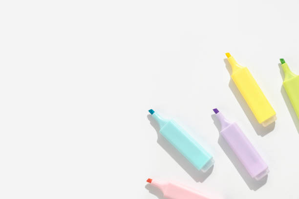 Colored markers on a white background. Top view; flat lay.