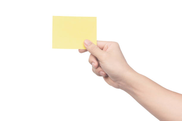 istock Hand holding yellow paper isolated on white 1475106406