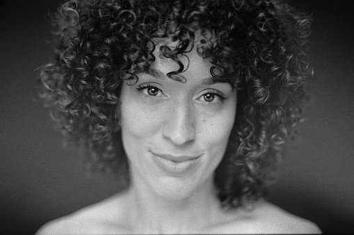 A portrait of a multiracial woman in a studio. Taken on 35mm black and white film and scanned.