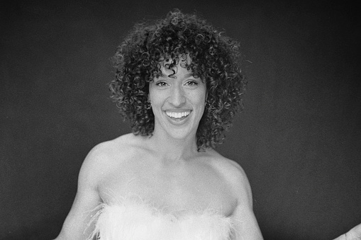 A portrait of a multiracial woman in a studio. Taken on 35mm black and white film and scanned.