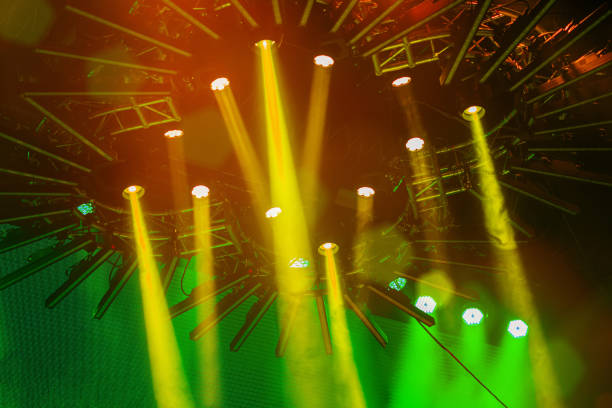 Bright colorful stage spotlights, light smoke, abstract blurred background