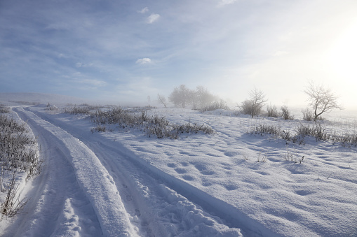 Winter scene from a hill in Arganda after the snowstorm in January 2021. Sky with long clouds