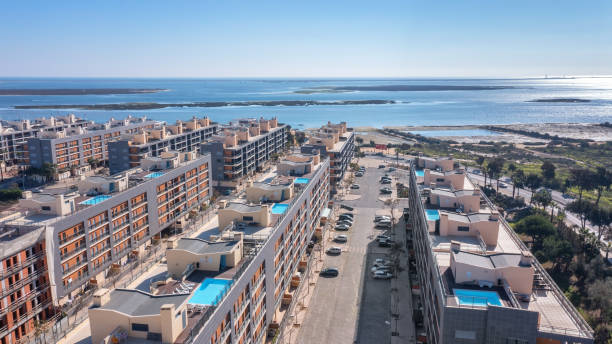 Aerial view of the Portuguese fishing tourist town of Olhao overlooking the Ria Formosa Marine Park. residential area with rooftop pool stock photo