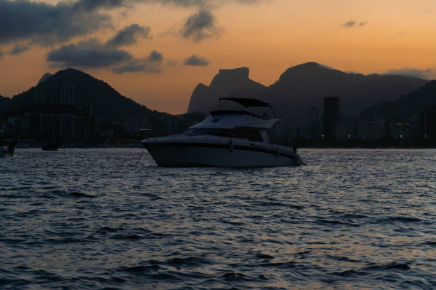 sunset in the bay of guanabara, cove and beaches of rio de janeiro, brazil with its buildings, boats and landscape. reflection of the sky in the sea - flamengo 個照片及圖片檔