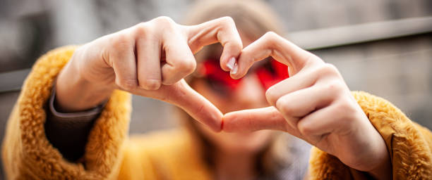 Girl making a heart shape with her hands and fingers