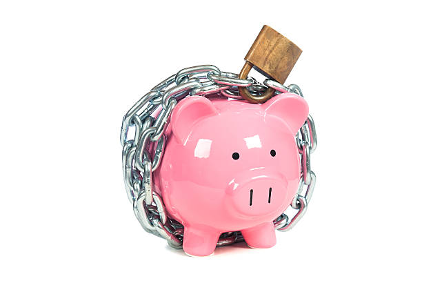 Pink piggybank with a padlock around it stock photo