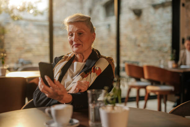 istock Cheerful businesswoman using cellphone on lunch break. 1475117590