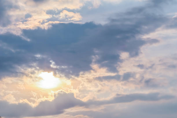 Cloudy sky background with sunlight through clouds Cloudy sky background with sunlight through clouds overcast stock pictures, royalty-free photos & images