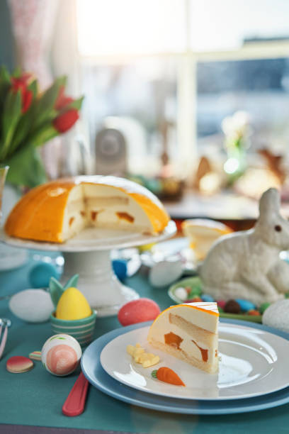 istock Colorful Decorated Easter Table with Easter Eggs, Flowers and Carrot Easter Cake 1475119707