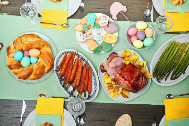 istock Easter Lunch with Roast Pork, Vegetables, Easter Cookies and Easter Cake 1475119750