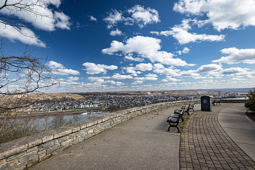 On a hill in Cincinnati, Ohio, there is an observation point with concrete flooring and rows of benches facing the Ohio River. Across the river, on the opposite bank, lie the small cities of Covington, Newport, and Bellevue in Kentucky.