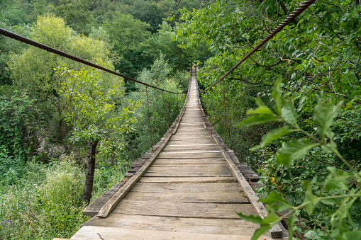 Old wooden suspension bridge in canyon of the river Nera in the National park Nera-Beusnica.