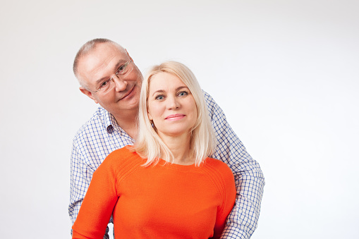 Studio portrait of an adult heterosexual couple against a white background