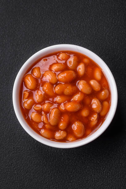 istock Delicious canned beans in a tomato in a white ceramic bowl 1475124321
