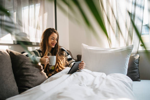 istock Woman reading digital book and drinking tea 1475125198