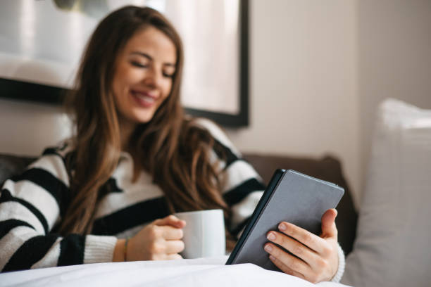 istock Woman reading digital book and drinking tea 1475125212