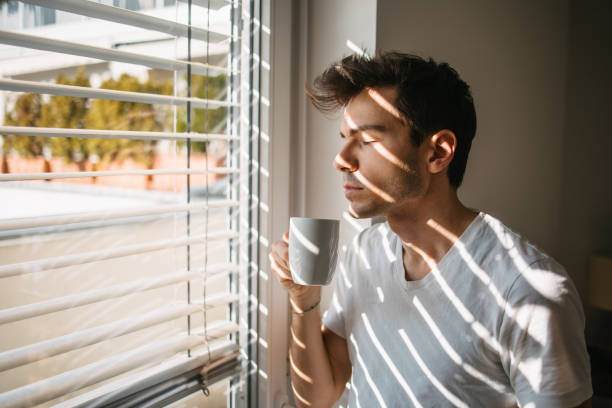 istock Looking through the window and enjoying some tea or coffee 1475125240