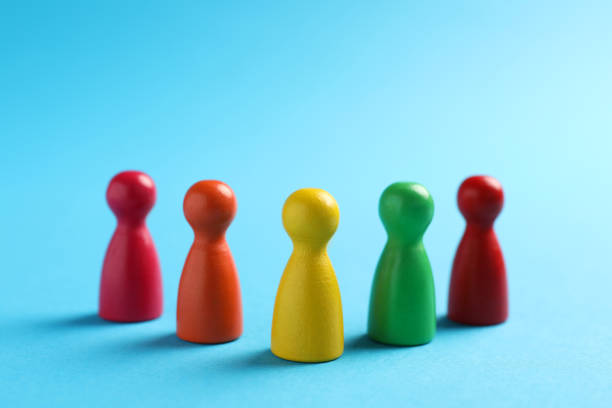istock Colorful pawns on light blue background, closeup. Social inclusion concept 1475126685